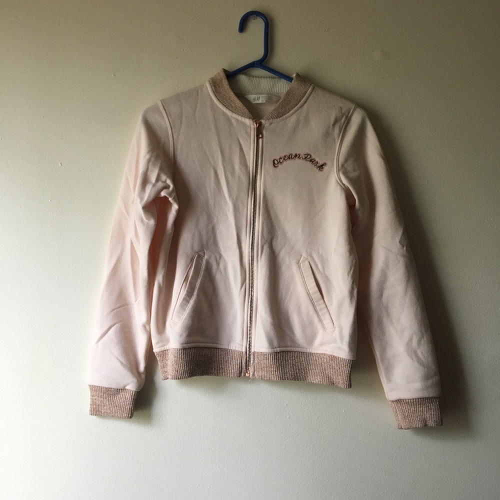 light pinkish hoodie with writing